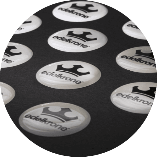 Round printed labels on a release sheet. Review text contrast and the spacing inside the finished outline.